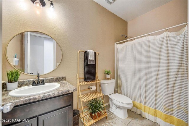 10429 W Crown King Rd, Tolleson, AZ 85353 - bathroom featuring tile patterned flooring, vanity, toilet, a shower with curtain, and a textured wall