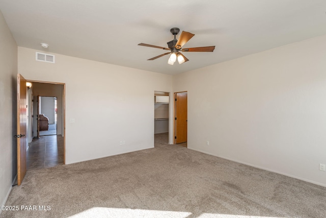 spare room with ceiling fan and carpet flooring