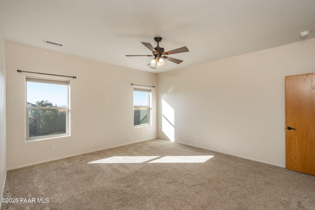 unfurnished room with ceiling fan and light carpet