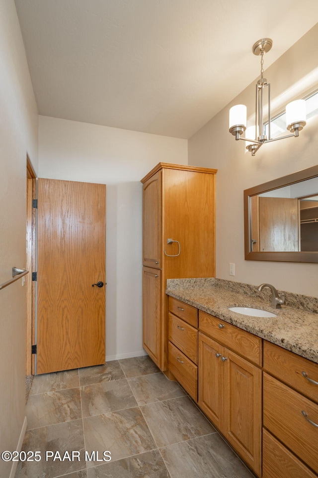 bathroom with vanity and a chandelier