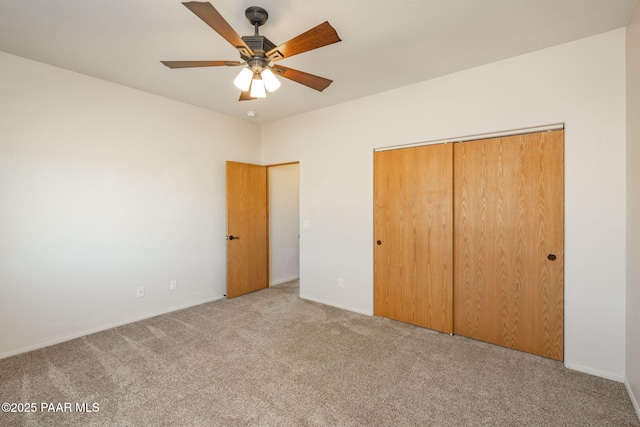 unfurnished bedroom featuring a closet, ceiling fan, and light carpet