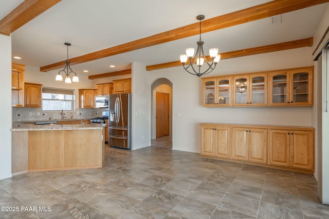 kitchen with pendant lighting, backsplash, light stone counters, a notable chandelier, and stainless steel appliances