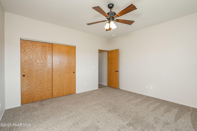 unfurnished bedroom with a closet, ceiling fan, and carpet flooring