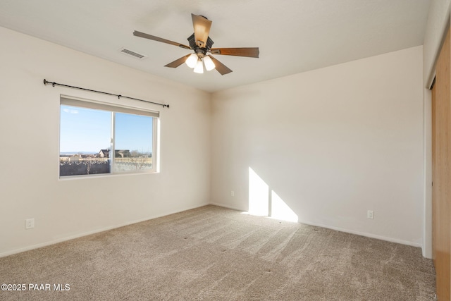 carpeted spare room with ceiling fan