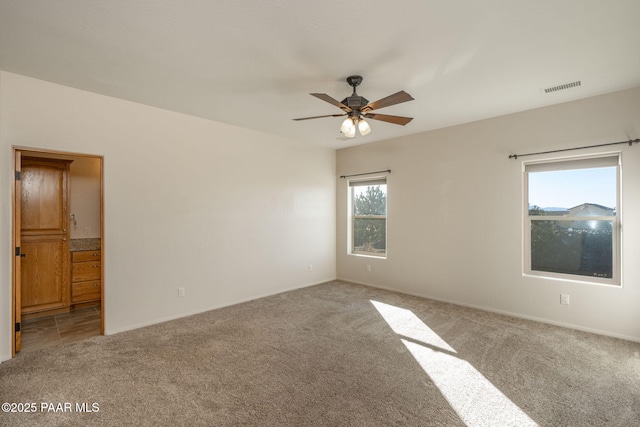 empty room with carpet floors and ceiling fan