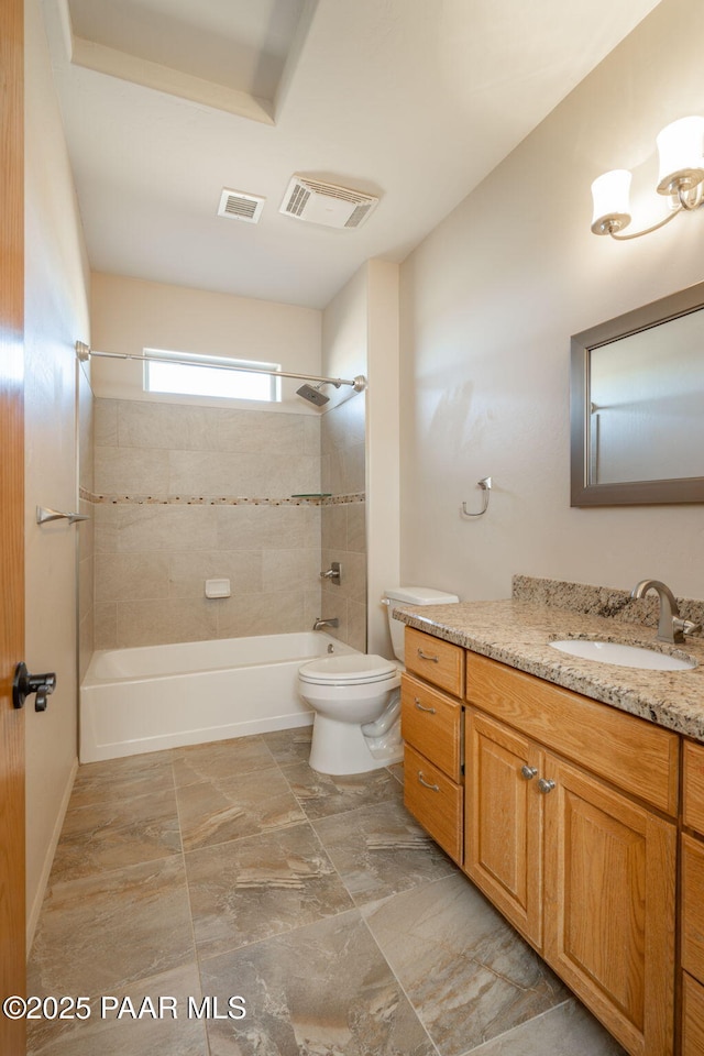 full bathroom featuring toilet, vanity, and tiled shower / bath