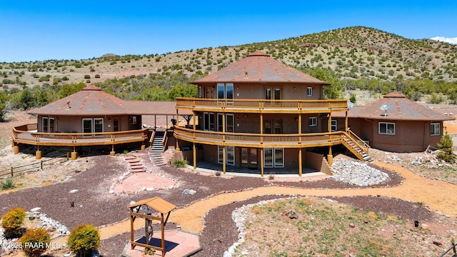 18900 N Butte Pass Rd, Prescott, AZ 86305 - back of house with stairs, a deck with mountain view, and stucco siding