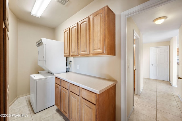 18900 N Butte Pass Rd, Prescott, AZ 86305 - clothes washing area featuring light tile patterned flooring, stacked washing machine and dryer, cabinet space, and baseboards