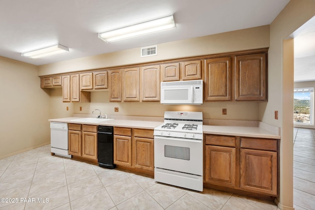 18900 N Butte Pass Rd, Prescott, AZ 86305 - kitchen featuring white appliances, a sink, light countertops, and light tile patterned floors