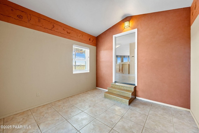 18900 N Butte Pass Rd, Prescott, AZ 86305 - empty room featuring light tile patterned flooring, lofted ceiling, and baseboards