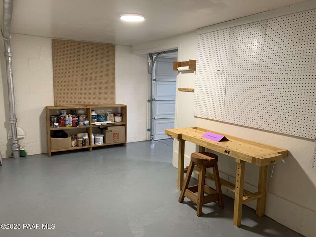 garage featuring concrete block wall and a workshop area