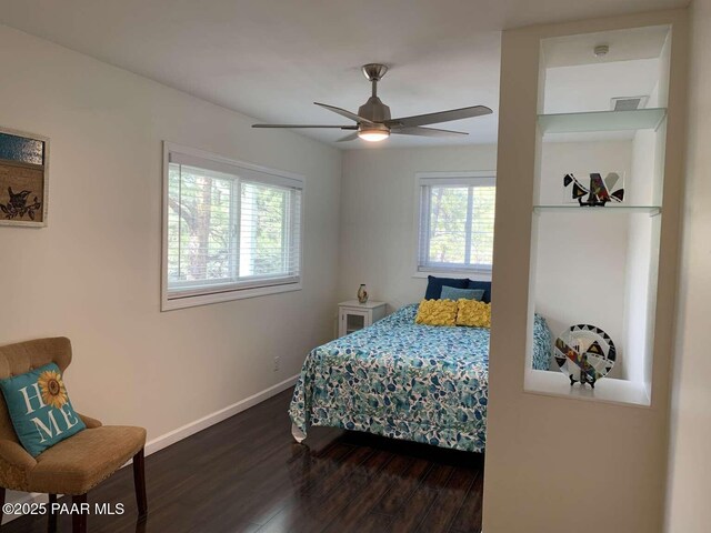 bedroom featuring visible vents, baseboards, ceiling fan, and wood finished floors