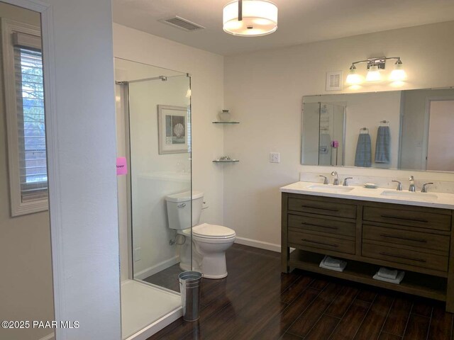 full bathroom featuring wood finished floors, a sink, and visible vents