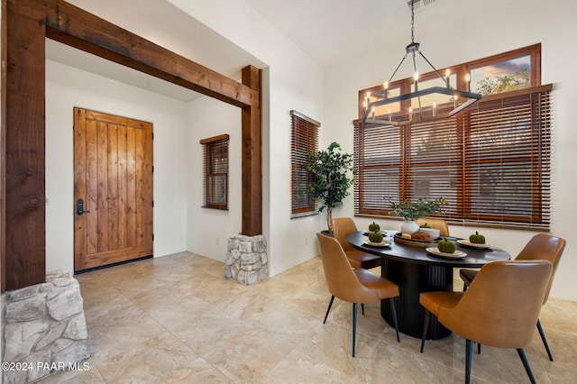 dining space with an inviting chandelier