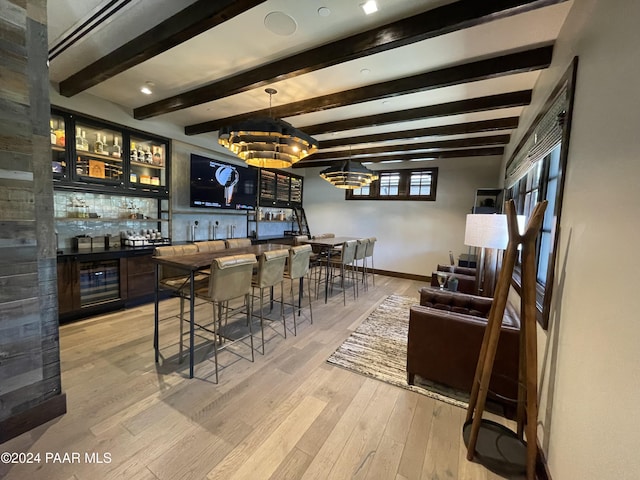 bar with decorative backsplash, light hardwood / wood-style flooring, beamed ceiling, and a chandelier