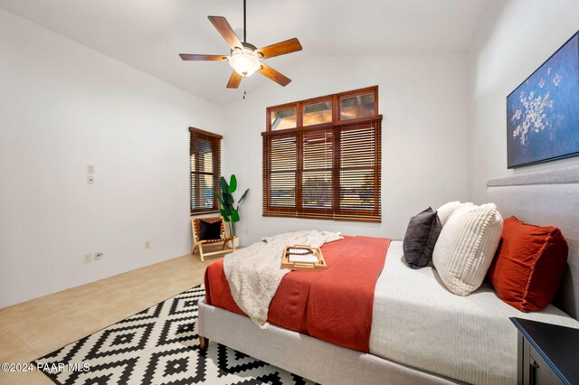 bedroom featuring tile patterned floors, ceiling fan, and lofted ceiling