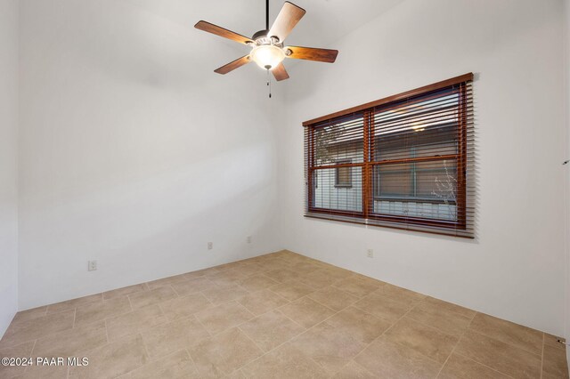 tiled empty room with ceiling fan