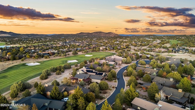 aerial view at dusk featuring a mountain view