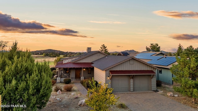 view of front of property featuring a mountain view and a garage