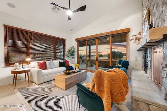 tiled living room featuring ceiling fan and high vaulted ceiling