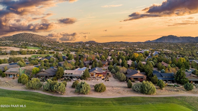 aerial view at dusk featuring a mountain view