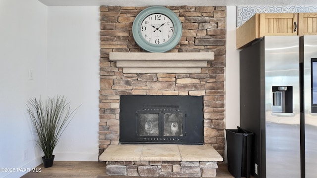 477 W State Route 260, Camp Verde, AZ 86322 - room details featuring stainless steel refrigerator with ice dispenser, baseboards, a stone fireplace, and wood finished floors