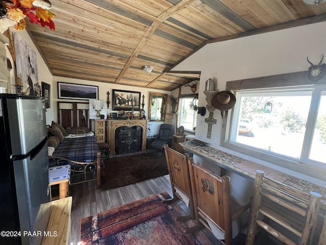 interior space featuring stainless steel fridge, dark wood-type flooring, lofted ceiling, and wood ceiling