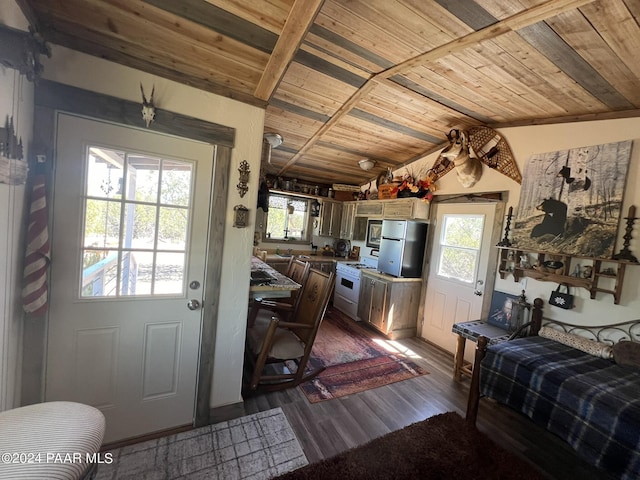 kitchen with wooden ceiling, stainless steel appliances, vaulted ceiling, and dark wood-type flooring