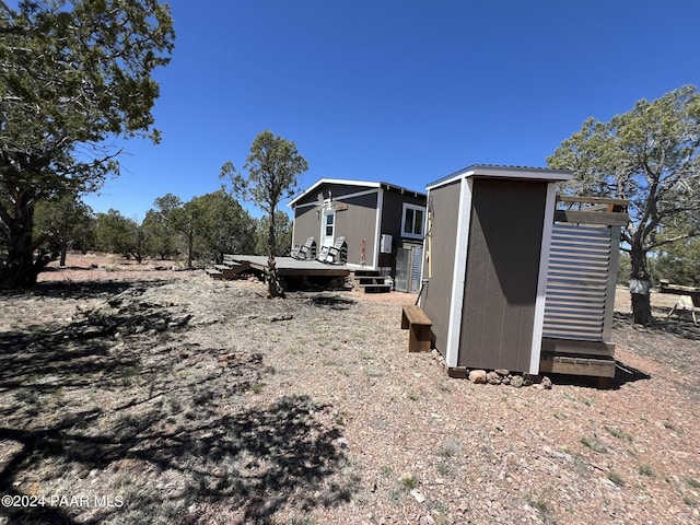 182 NE Cooks Trl, Ash Fork, AZ 86320 - view of yard featuring a deck and a shed
