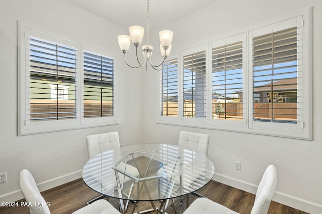 dining room featuring dark hardwood / wood-style flooring and a chandelier