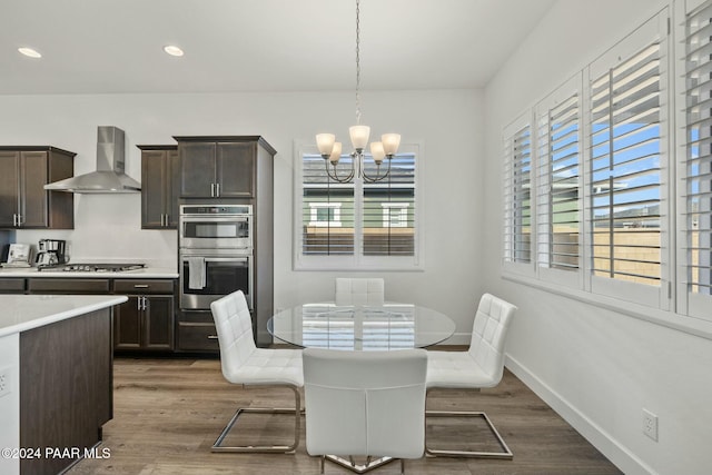 dining room with dark hardwood / wood-style floors and a chandelier