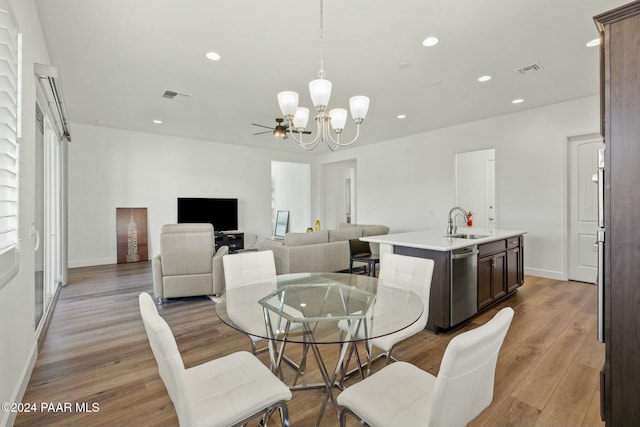 dining room featuring a chandelier, light hardwood / wood-style floors, and sink