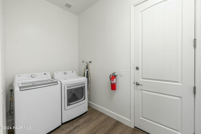 washroom featuring hardwood / wood-style flooring and washer and dryer