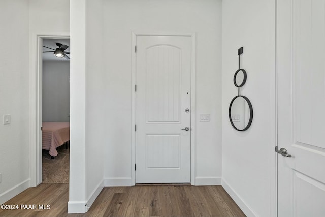 hallway with hardwood / wood-style flooring