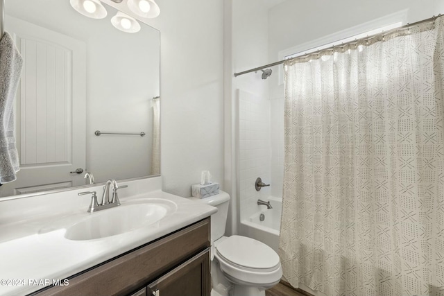 full bathroom with shower / bath combination with curtain, vanity, and toilet