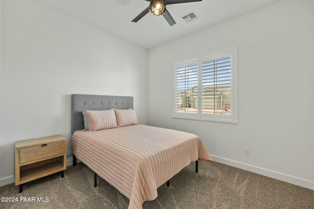 bedroom featuring ceiling fan and dark carpet