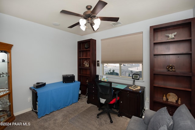 carpeted office space featuring ceiling fan