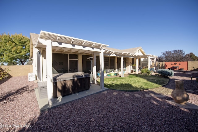 back of house with a pergola, a patio, and a hot tub