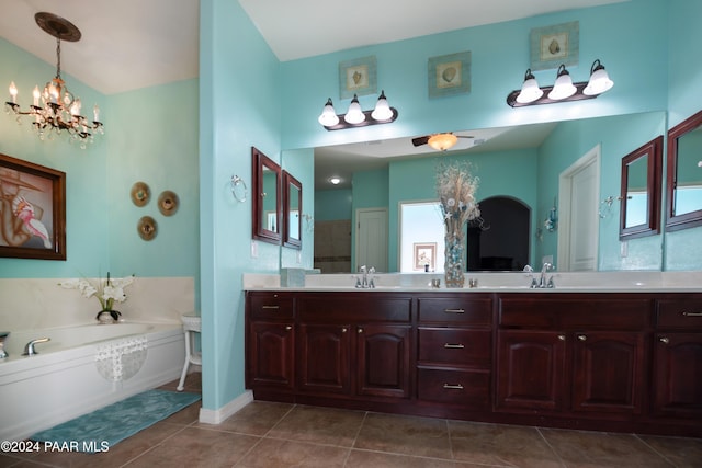 bathroom featuring a washtub, vanity, a chandelier, and tile patterned floors