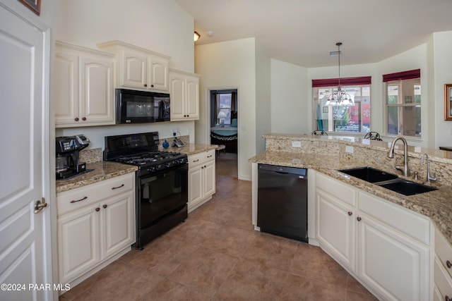 kitchen featuring sink, black appliances, pendant lighting, light tile patterned floors, and a chandelier