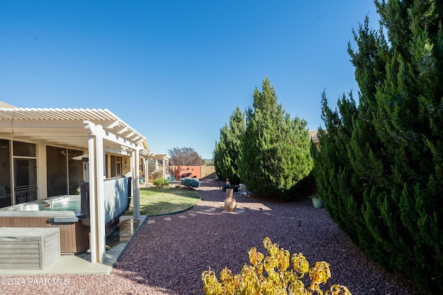 view of yard with a pergola and a hot tub