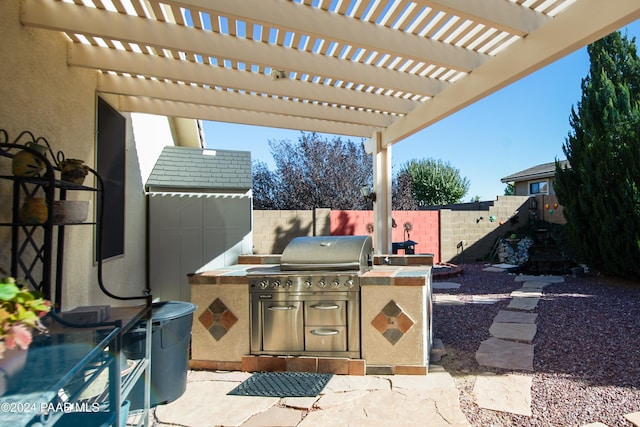 view of patio with a pergola, a grill, and exterior kitchen