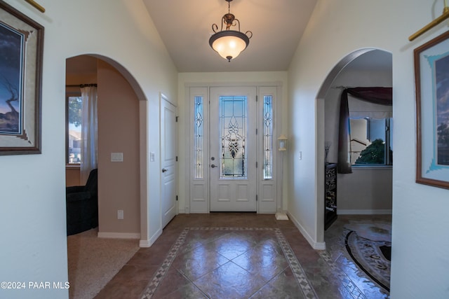 foyer entrance featuring plenty of natural light and vaulted ceiling