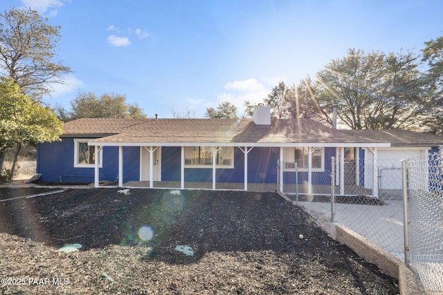 ranch-style house with an attached garage and a chimney