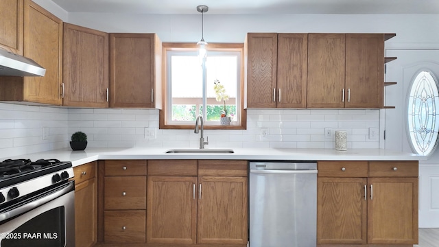 5640 N Burke Blvd, Rimrock, AZ 86335 - kitchen with stainless steel appliances, a sink, brown cabinetry, and decorative backsplash
