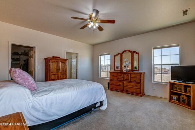 bedroom with light carpet and ceiling fan