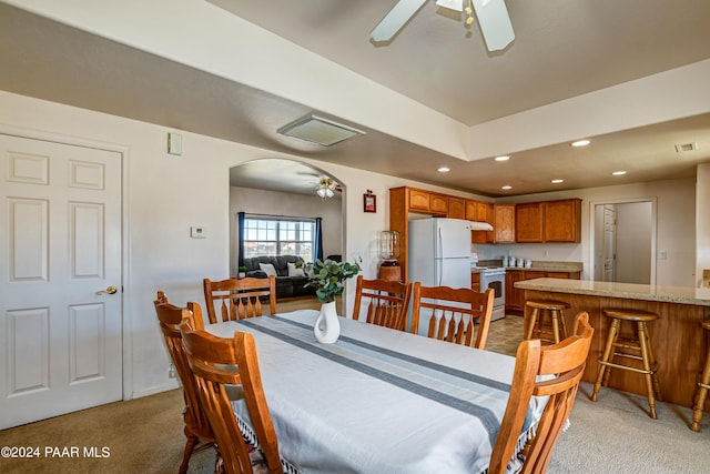 dining space with carpet and ceiling fan