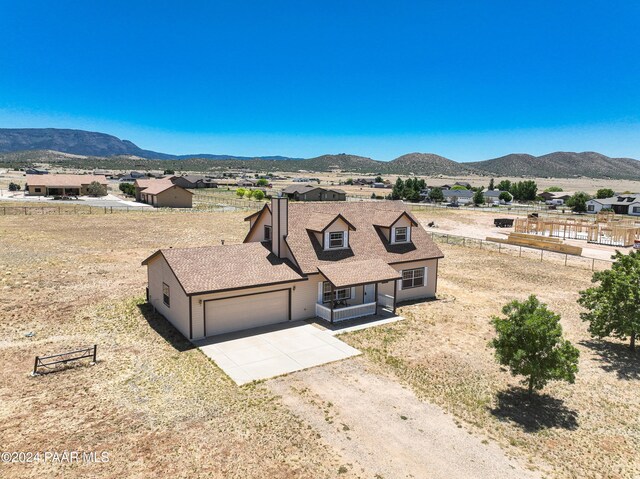 view of front of property featuring a mountain view and a garage