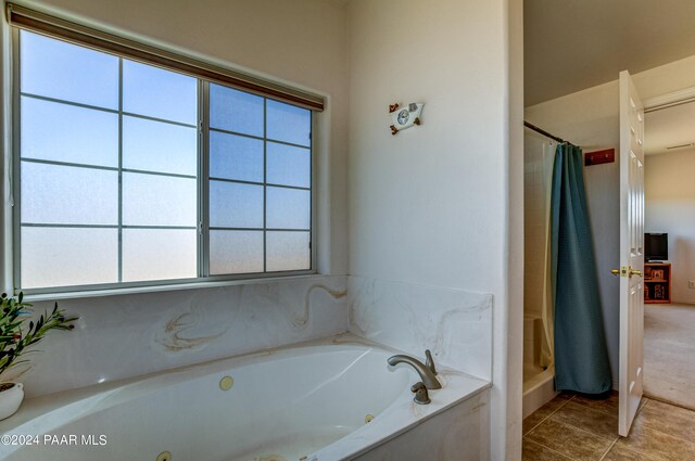 bathroom featuring tile patterned floors and shower with separate bathtub