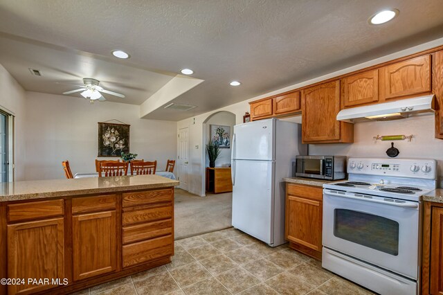 kitchen featuring a textured ceiling, ceiling fan, light tile patterned floors, and white appliances